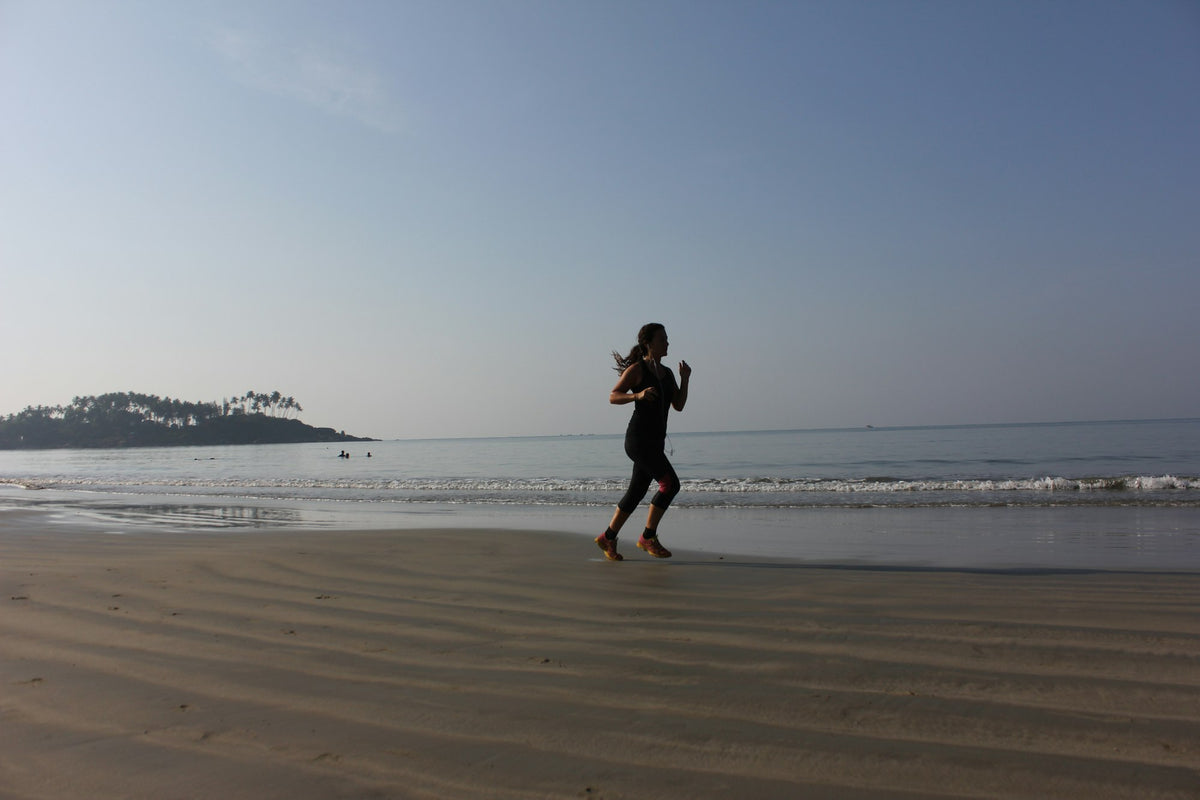 A runner on the beach in the morning